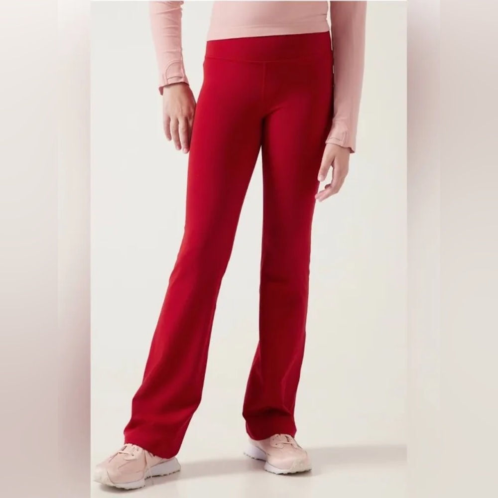 ATHLETA GIRL HIGH RISE CHIT CHAT FLARE PANT.    RUST RED